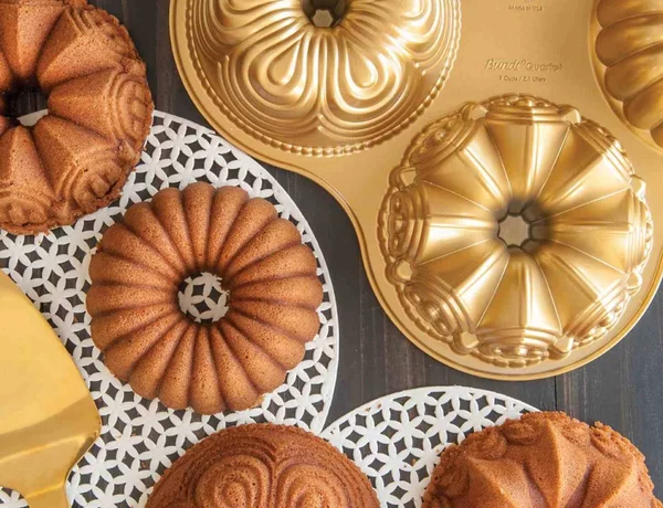 Φόρμα για κέικ Nordic Ware Premier Gold σε 4 σχέδια, με τρύπα και διαστάσεις 38x6cm